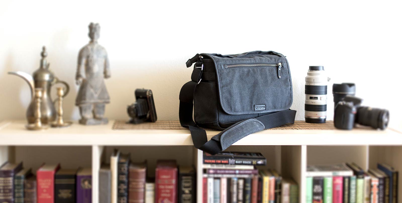 Tenba Cooper Series 13 DSLR Bag on book case.