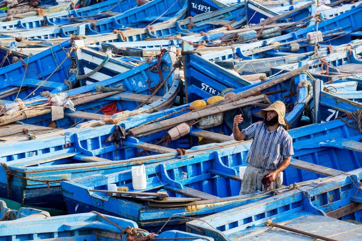 fisherman and blue boats in Essaouira, Morocoo