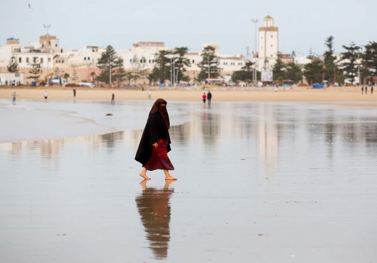 Woman in burkha on the beach