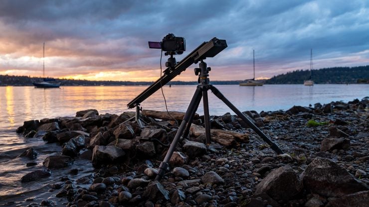 Photo of a tripod and camera rail slider at sunset