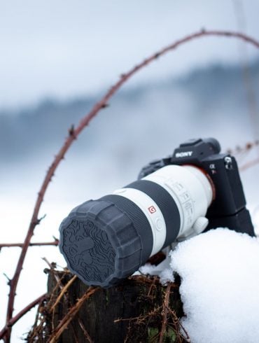 Camera in snowy scene with Polar Pro Defender Lens Cap