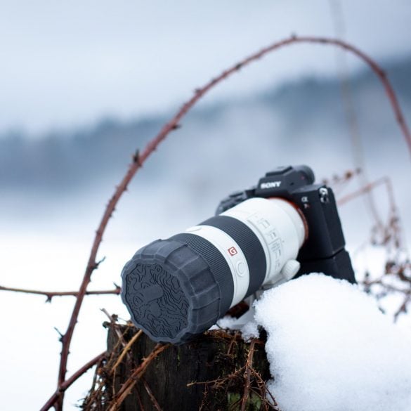 Camera in snowy scene with Polar Pro Defender Lens Cap