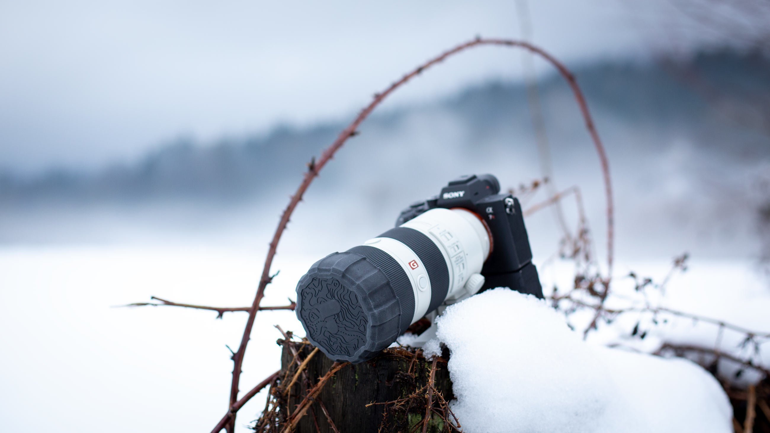 Camera in snowy scene with Polar Pro Defender Lens Cap