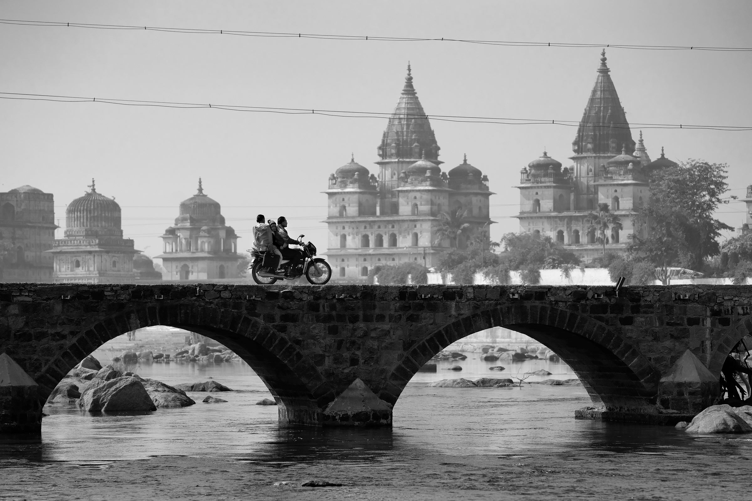 motorcycle on betwa river bridge in orchha