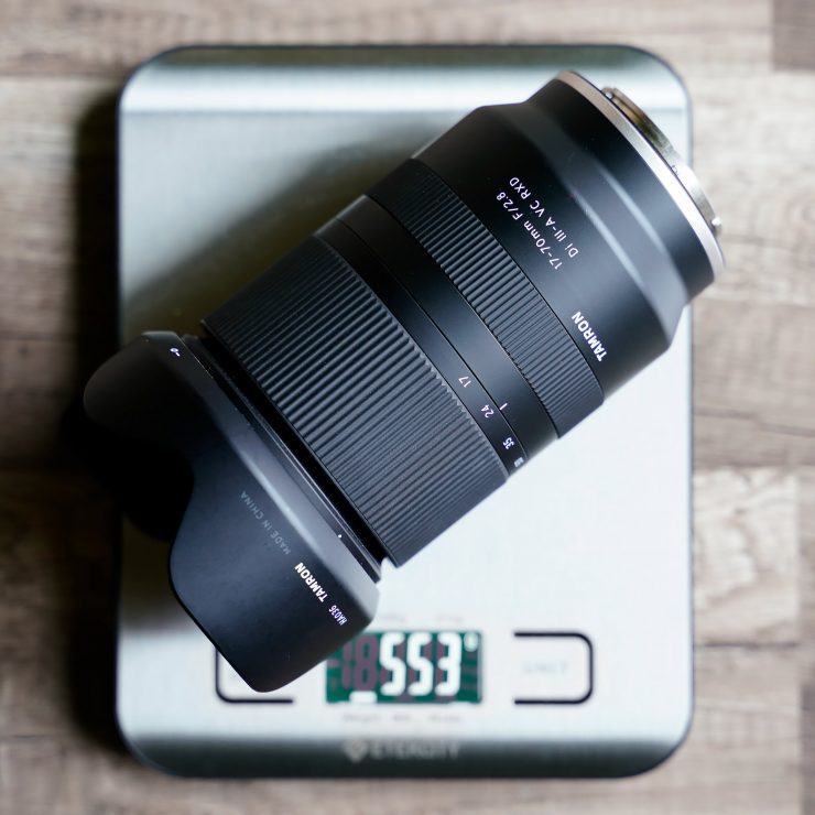 Image of Tamron 17-70mm lens on scale reading 553 grams