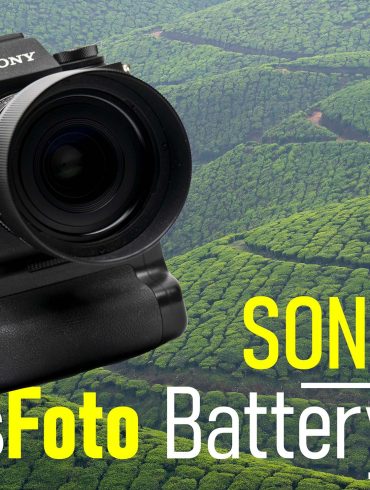 camera with battery grip in front of tea fields and hills