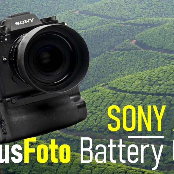 camera with battery grip in front of tea fields and hills